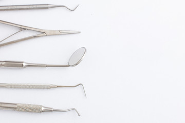 Dentist mirror tool on the table with white background. Dentist equipment.