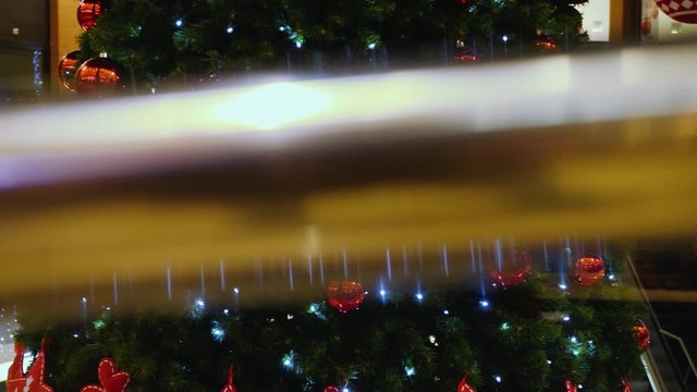 Slider shot of a big christmas tree standing in the middle of a mall