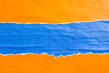 Blue and orange crumpled, torn and shabby gloss paper posters and placards texture background. Can be used for text.