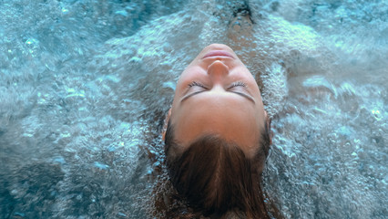 Close up of an young female is enjoying and having relax in a whirlpool bath tube in a luxury...
