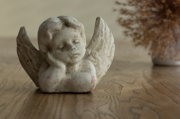 old stone romantic angel on brown table