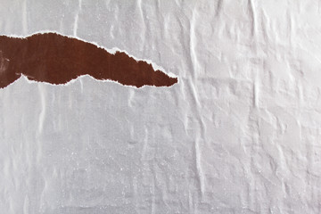 Silver grey and brown torn and ripped shabby gloss paper posters or placards texture background....
