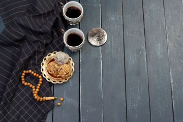 Nut balls dessert served with coffee on dark wooden table, top view