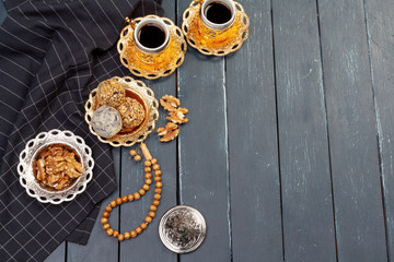 Nut balls dessert served with coffee on dark wooden table, top view