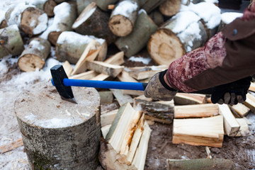 Man chopping wood in the winter.