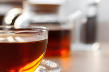 Hot cup of tea on wooden rustic table close up