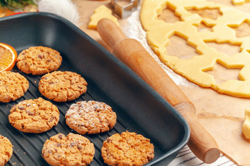 Top view of oat cookies in baking tray on wooden table