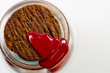 Natural cork in a glass bottle sealed with red sealing wax filmed on a large white background