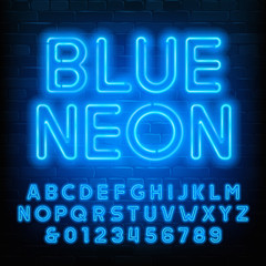 Blue Neon alphabet font. Uppercase neon light letters and numbers. Brick wall background. Stock vector typescript for your typography design. © epifantsev