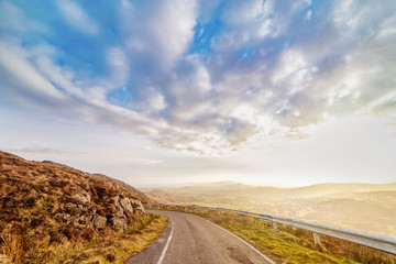 Beautiful hazy landscape with  road at the foot of the Mount Gabriel