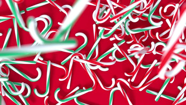 Abstract different color Chirstmas Candys Falling Down on Red Surface Background. 4k 3D Render Holiday Animation.