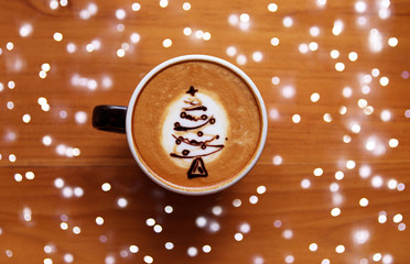 Tasty cappuccino with Christmas tree latte art