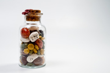 Glass jar with sweets closed by a cork and sealed with red wax