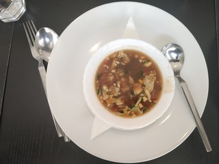 Top view of chicken soups white plate