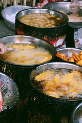 boiling oil pan on charcoal stove, crispy snacks cake powder