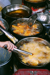 boiling oil pan on charcoal stove, crispy snacks cake powder