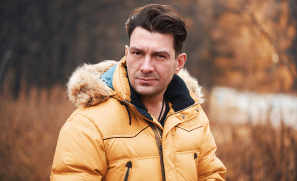 Man Is Wearing Winter Jacket In The Park