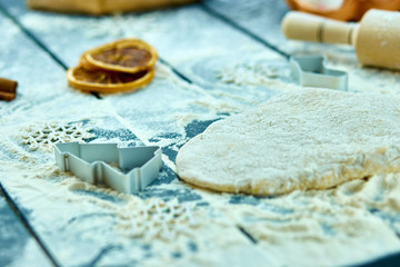 Christmas baking background. Raw dough for Christmas cookies. Kitchen utensils and ingredients for cooking baking