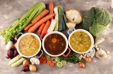 Set of soups from worldwide cuisines, healthy food. Broth with noodles, beef soup and broth with marrow dumplings. All soups with healthy vegetables on table