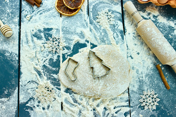 Christmas baking background. Raw dough for Christmas cookies. Kitchen utensils and ingredients for...