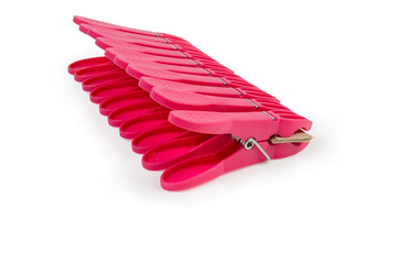 Set of red plastic clothespins on a white background