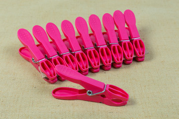 Red plastic clothespins on the cloth surface