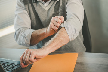 Businessman rolling up his sleeves