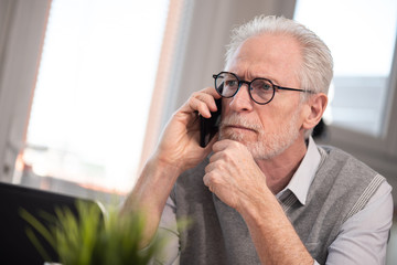 Senior businessman talking on mobile phone
