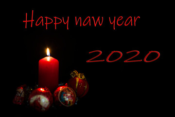 Fototapeta na wymiar New year red candle with balls. Happy New Year. Writing space, postcard, book