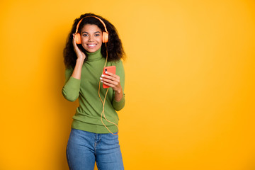 Photo of trendy cheerful positive cute pretty girlfriend youngster standing near empty space smile toothy in jeans denim curly wavy isolated vivid color background
