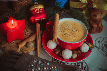 Cozy Christmas cup of coffee, magic evening at home. Scene of holidays detail