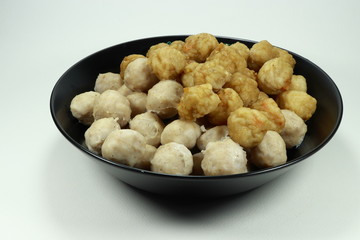Fresh pork ball and shrimp ball on the black bowl. Main ingredient in Asia noodle.