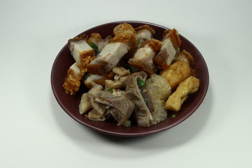 Grilled crispy pork and tofu on the plate. Famous ingredient in Chinese noodle.