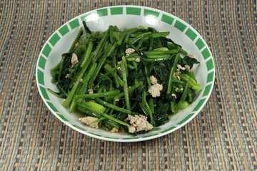 Fried Spinach with chopped pork and garlic. Mix tasty with soy sauce, sugar and pepper. Famous Chinese menu in restaurant.