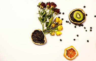 Red and yellow roses on a white background. Dry orange as decoration.