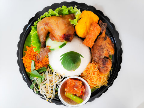 Nasi Tumpeng. Yellow rice in a cone shape. A festive Indonesian rice dish with side dishes