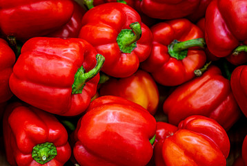 Red bell pepper close-up, wallpaper, pattern. A lot of ripe red pepper, the concept of the crop, veggie nutrition, vitamin food.