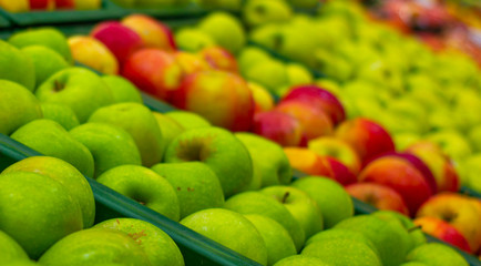  Apples in the store. Rows of apples in a supermarket. Boxes filled with apples of different varieties and colors in the store. The concept of harvest, healthy nutrition, healthy lifestyle, organic. 