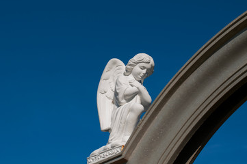 statue of an angel and Jesus in the open air