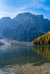 Autumn peaceful alpine lake Braies or Pragser Wildsee. Fanes-Sennes-Prags national park, South Tyrol, Dolomites Alps, Italy, Europe. Picturesque traveling, seasonal and nature beauty concept scene.