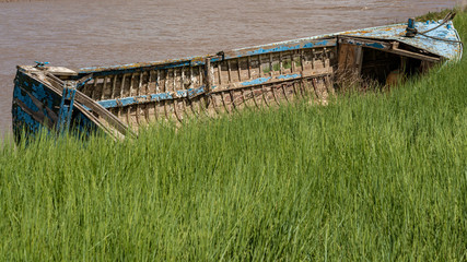 A decayed boat near the shore of the River Avon in the Pill Foreshore in Pill, North Somerset,...