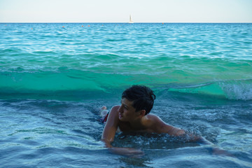 Boy enjoying the waves  at the beach
