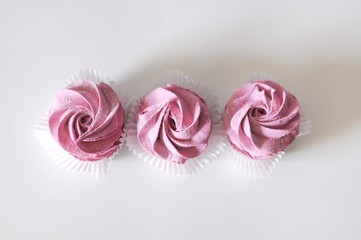 Homemade marshmallow berry zephyr on white background top view