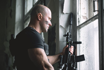 Concept photo of special agent man with a rifle. Person with airsoft gun. Thriller film concept.