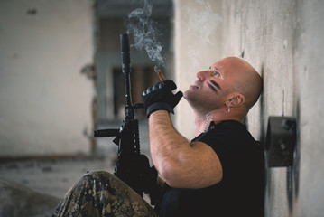 Concept photo of special agent man with a rifle. Person with airsoft gun. Thriller film concept.