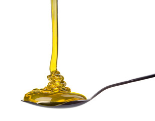 Falling and flowing honey on a spoon isolated on white with clipping path