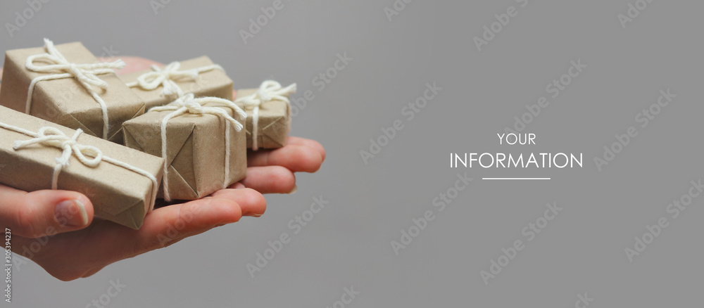 Wall mural hands hold set of gift boxes. delivery service. gray background. gift exchange. web article template