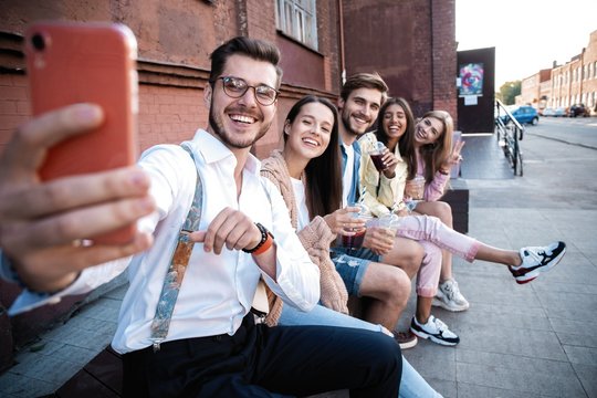 holidays, vacation and happiness concept - group of friends taking selfie with smartphone
