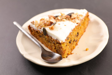 carrot cake with cream and nuts, slice
