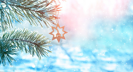 Christmas holiday background. snow-covered tree and Christmas star, symbol of Christmas on winter...